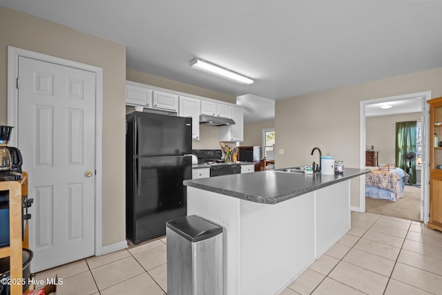 kitchen featuring sink, white cabinetry, light tile patterned floors, an island with sink, and black appliances