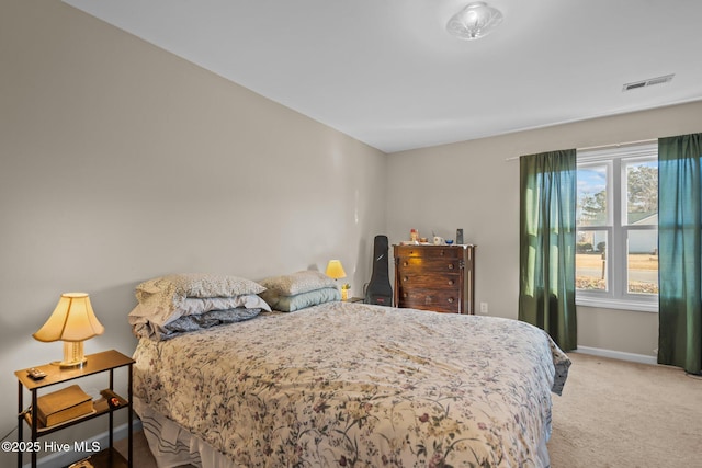 bedroom featuring light colored carpet