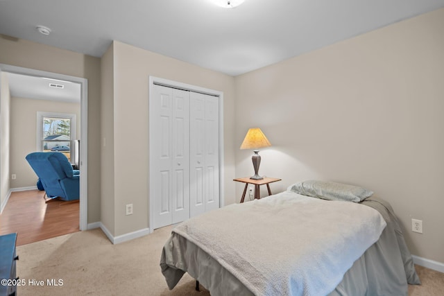 bedroom with light colored carpet and a closet