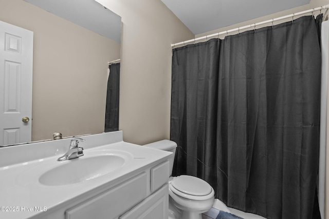 bathroom with vanity, toilet, and a shower with shower curtain