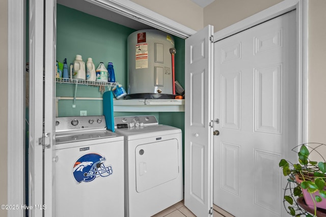 laundry room with water heater, light tile patterned floors, and washer and dryer