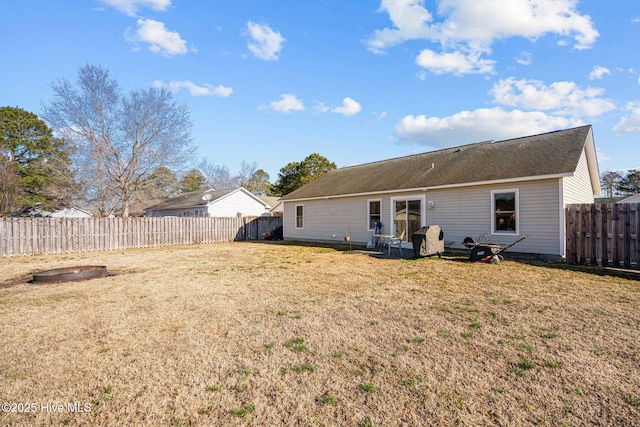 rear view of property featuring a yard