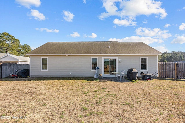 back of house with a yard