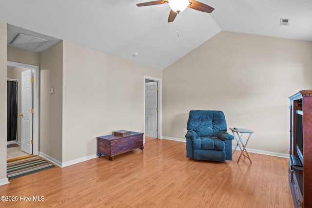 unfurnished room with ceiling fan, lofted ceiling, and light wood-type flooring