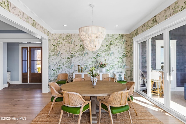 dining space with crown molding, dark hardwood / wood-style floors, and a chandelier