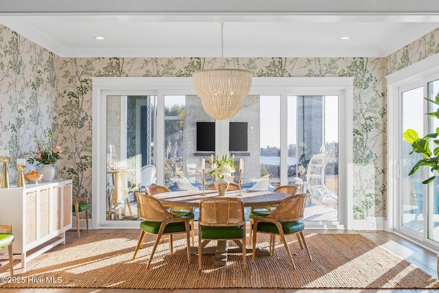 dining room with a notable chandelier and crown molding