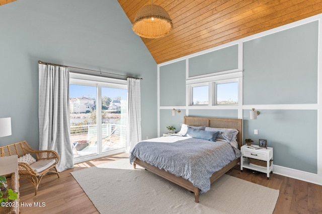 bedroom with wooden ceiling, hardwood / wood-style floors, access to exterior, and high vaulted ceiling