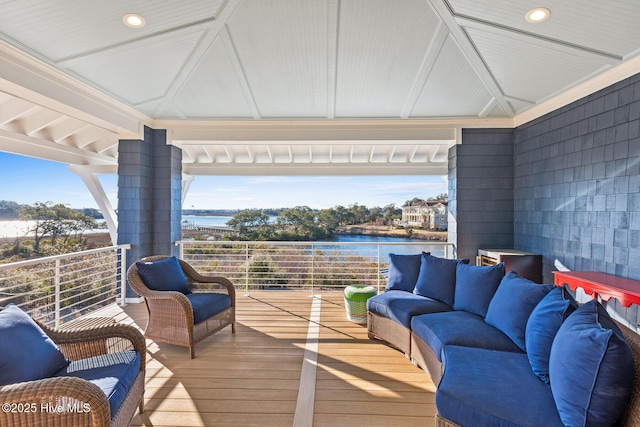 wooden deck featuring a water view and outdoor lounge area