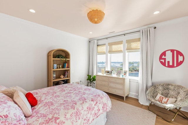 bedroom featuring hardwood / wood-style flooring and crown molding