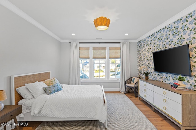 bedroom with crown molding and light wood-type flooring