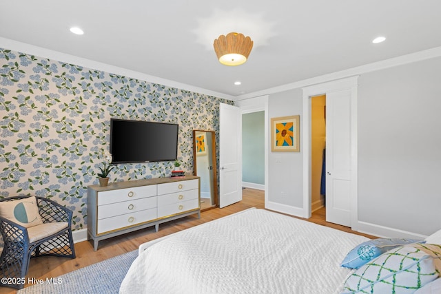 bedroom with crown molding and light wood-type flooring