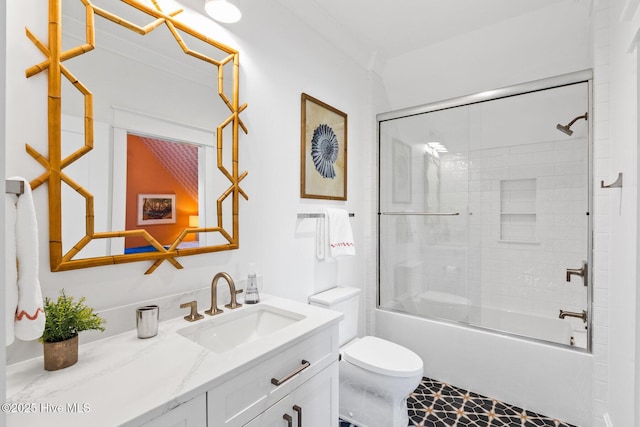 full bathroom featuring vanity, combined bath / shower with glass door, and toilet