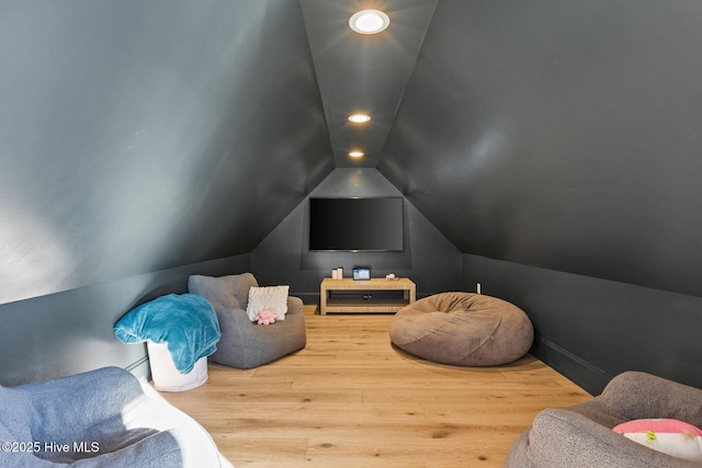 recreation room with vaulted ceiling and hardwood / wood-style floors