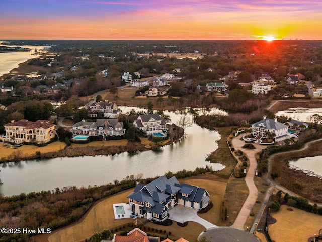 aerial view at dusk with a water view