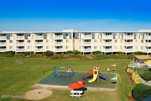 view of community with a yard and a playground