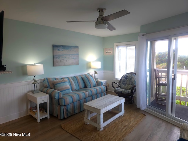 living room with wood-type flooring and ceiling fan