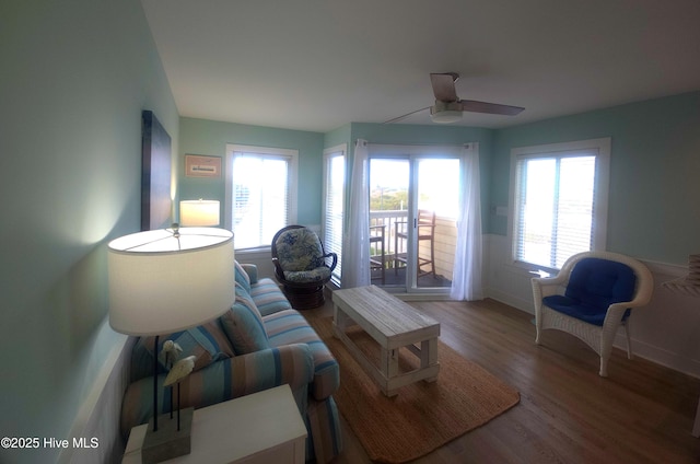 living room with wood-type flooring and ceiling fan