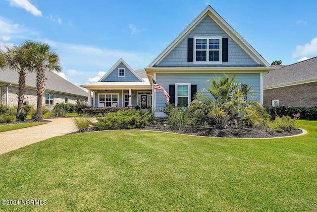 craftsman house featuring a front lawn and a porch