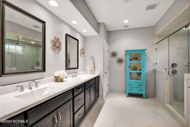 bathroom featuring vanity and a shower with shower door