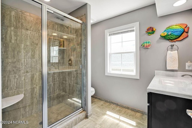 bathroom with vanity, an enclosed shower, and toilet