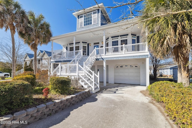 coastal home with a garage and a porch