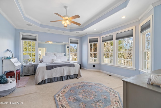 bedroom featuring a raised ceiling, crown molding, light carpet, and ceiling fan