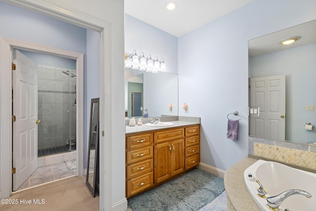 bathroom with tile patterned floors, vanity, and shower with separate bathtub