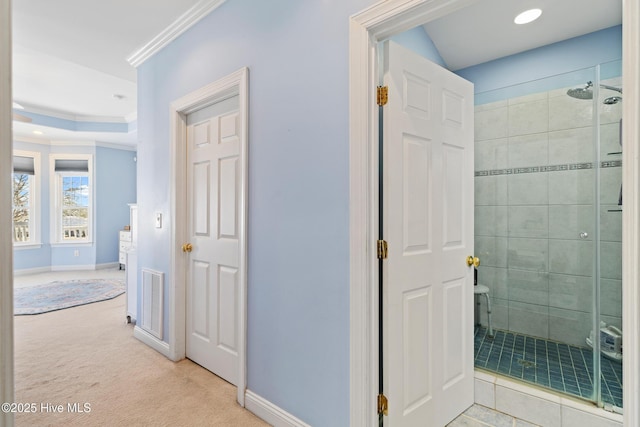 hallway with light colored carpet and ornamental molding