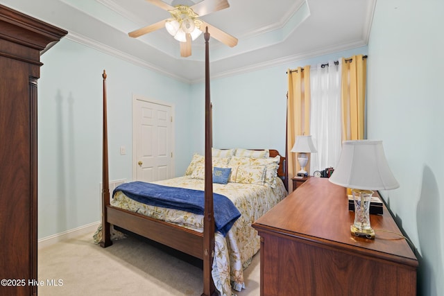 carpeted bedroom featuring crown molding, ceiling fan, and a tray ceiling