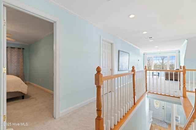 hall with light carpet and crown molding