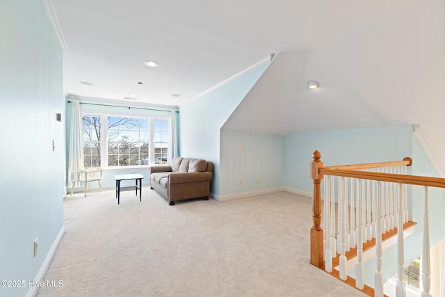 living area with ornamental molding and light colored carpet