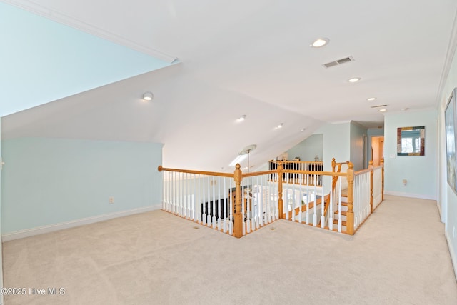 bonus room with lofted ceiling and light colored carpet