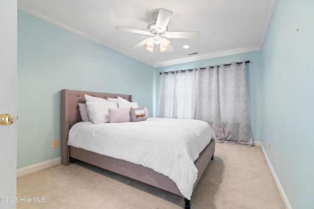 carpeted bedroom with ornamental molding and ceiling fan