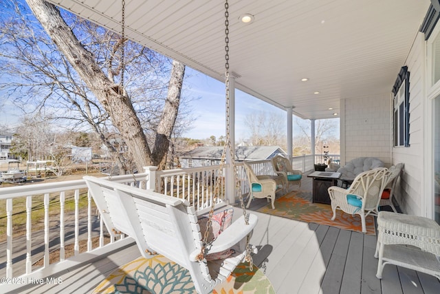 wooden terrace featuring an outdoor living space