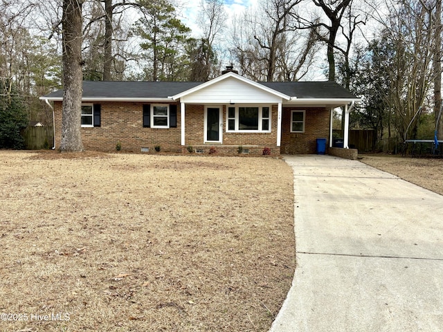 single story home featuring a carport and a trampoline