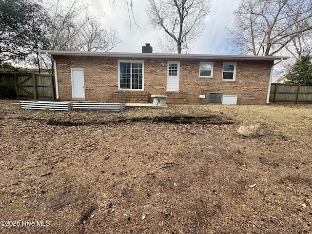 rear view of house featuring central AC