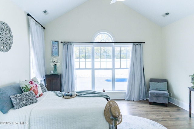 bedroom featuring hardwood / wood-style flooring and lofted ceiling