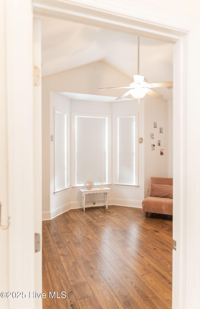 unfurnished room with hardwood / wood-style flooring, ceiling fan, and lofted ceiling