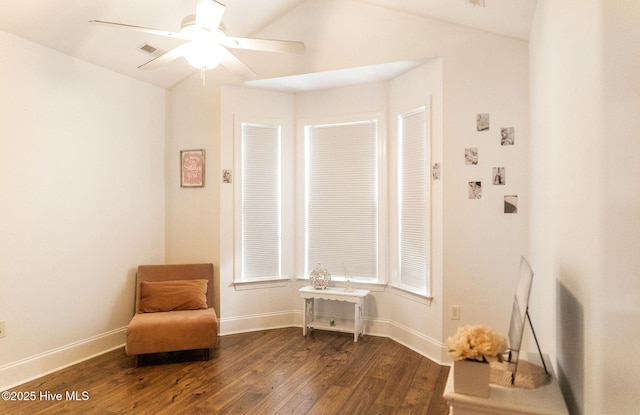 living area featuring ceiling fan, lofted ceiling, and dark hardwood / wood-style flooring