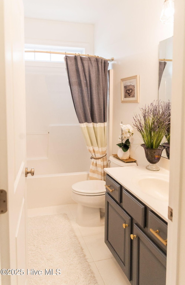 full bathroom with shower / bath combo with shower curtain, tile patterned floors, toilet, and vanity