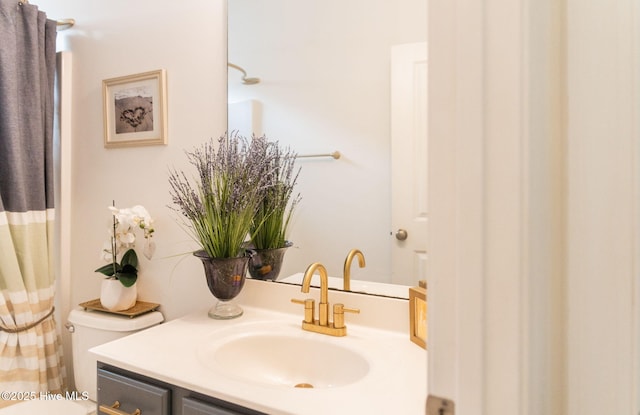 bathroom with vanity, a shower with shower curtain, and toilet