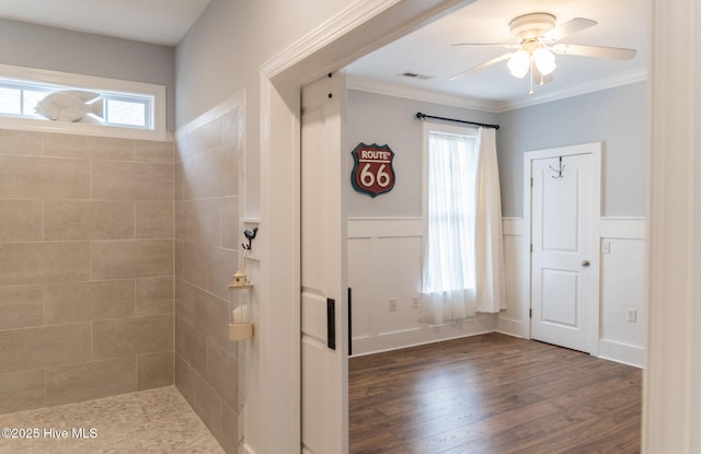 bathroom with crown molding, hardwood / wood-style flooring, and ceiling fan