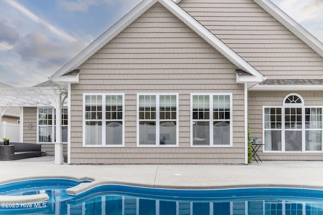 rear view of house featuring a pergola