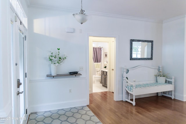 entryway featuring ornamental molding and wood-type flooring