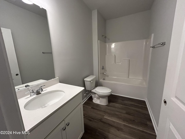 full bathroom with wood-type flooring, toilet, shower / washtub combination, and vanity