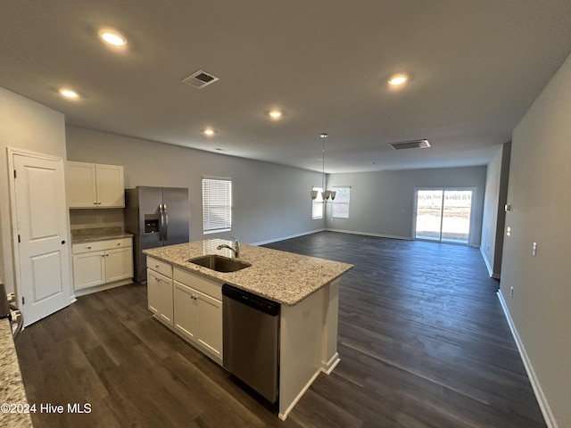 kitchen featuring white cabinetry, sink, stainless steel appliances, and a center island with sink