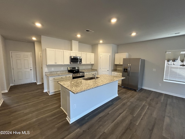 kitchen with sink, white cabinetry, a center island with sink, stainless steel appliances, and light stone countertops