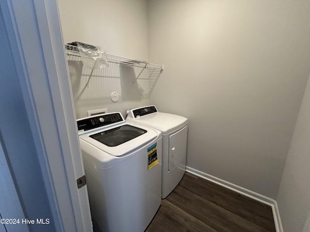 laundry area with washer and clothes dryer and dark hardwood / wood-style floors