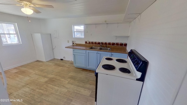 kitchen with white electric range, white cabinetry, sink, ceiling fan, and light hardwood / wood-style flooring