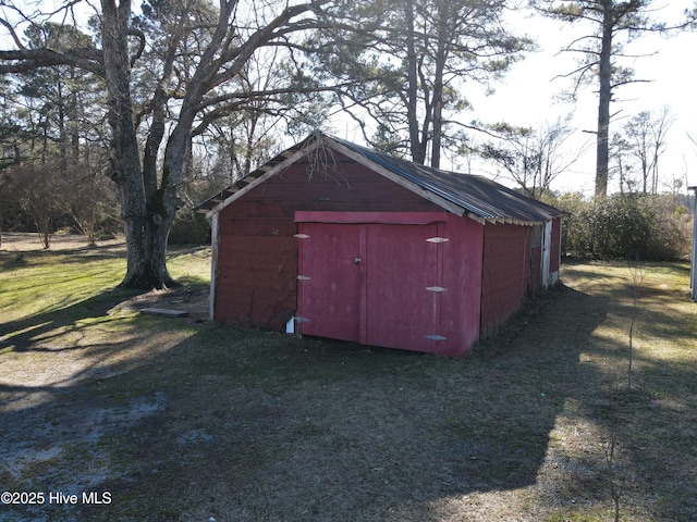 view of outdoor structure with a lawn